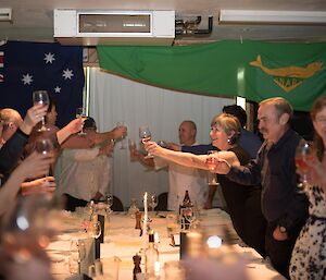 All guests standing around the table mid toast