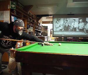 A man plays pool