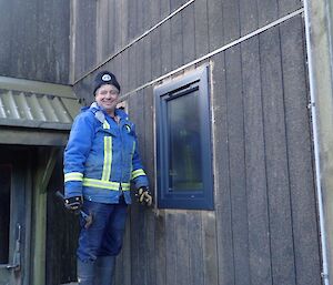 A man standing next to a new window