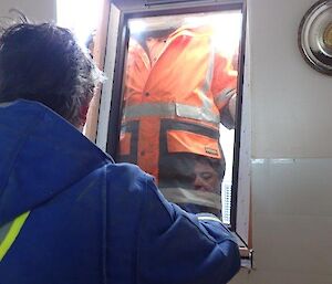 Two men fitting a window