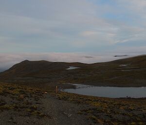 A view looking over the plateau where one seems level with the clouds