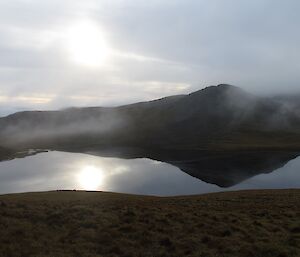 Square Lake without wind so there are actually reflections of the peak and clouds