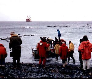 Tourists clamber back into their boat after visiting the island