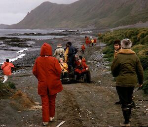 Tourists walking down the beach towards the Nuggets.