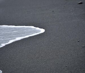 Detail of wave on the black sands of Hurd Point