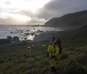 A man stands in front of a view of the bay