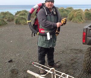 A man dressed ready to hike with antenna in foreground