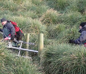 The two men set off with the aerial up the stairs