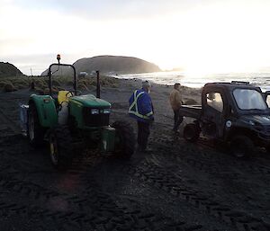 A tractor & polaris on the beach.