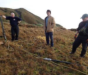 3 men looking at a rope hauling system