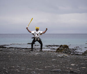 A man in knight’s costume on the beach