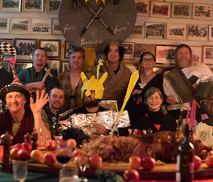 A group of people in costume in front of the photo wall.