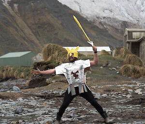 A man in knight’s costume on the beach