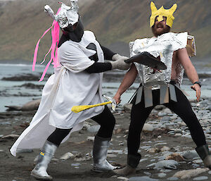 2 men in knight’s costume fight on the beach