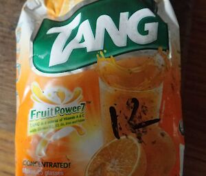 A packet of TANG orange drink powder