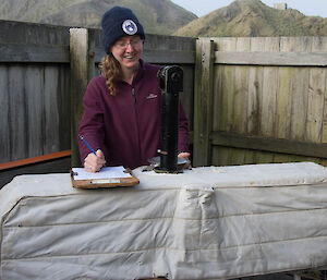 A woman using the Dobson to take a direct sun reading