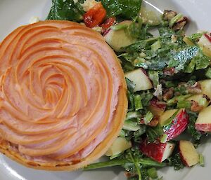 A pie with pink mash and fresh salad grown in hydroponics