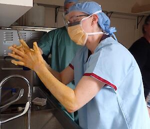 A woman scrubbing her hands pre surgery training