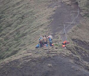 A group of people working on a cliff top