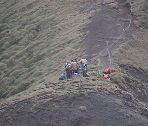 A group of people working on a cliff top