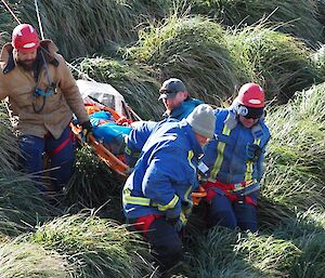 A team of expeditioners acting as a stretcher team carrying the patient out to safety