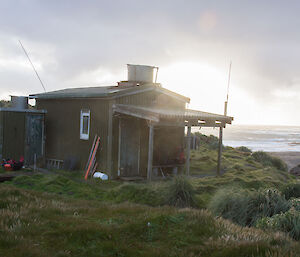 A picture of the Bauer Bay hut in 2016, which has a porch on it