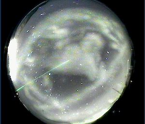 A view from the Skycam at the Clean Air Laboratory on 31 October showing aurora and lidar beam (Andrew K). The patches of light in the sky are mainly associated with pulsating aurora – slowly pulsing glows that arise from electrons bouncing between the hemispheres during disturbances in the Earth’s magnetic field.