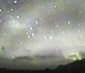 Projection of the Skycam image as a panorama with North Head at left and the plateau at right. The laser beam is titled 4 degrees from vertical to improve detection of falling ice crystals