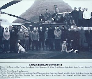A group photo of the 2011 Macquarie Island pest eradication project with Wags the dog
