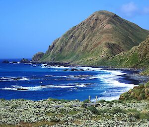 A view of Brothers Point with blue ocean and sky. The Googie visible on the ridge