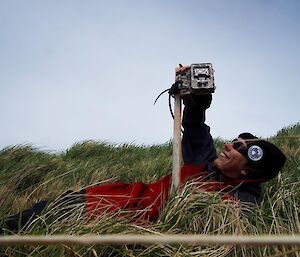 Penny changing the batteries on one of the remote monitoring cameras