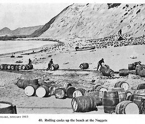 Men rolling barrels up the beach at the Nuggets 1913