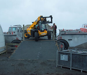 A JCB being unloaded from a LARC