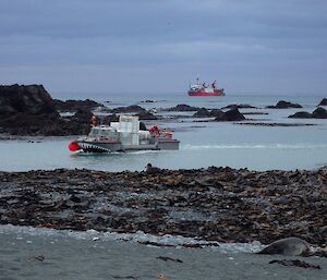 The ship sits off West Beach with a LARC coming in to land in foreground.