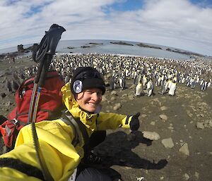 A lady in front of King penguins at Sandy Bay