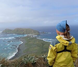 A lady in foreground with station and isthmus in background