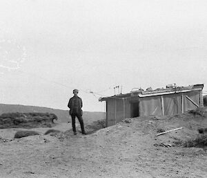 Wireless operating hut on Wireless hill with a man standing in front