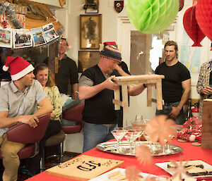 A man admires his gift of a stool.