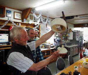 A man admires his desklamp present made ffrom debris found on the island