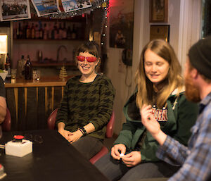 A woman in dark glasses playing a game.