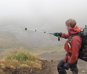 A wet man surveying a penguin colony