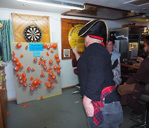 A man playing darts