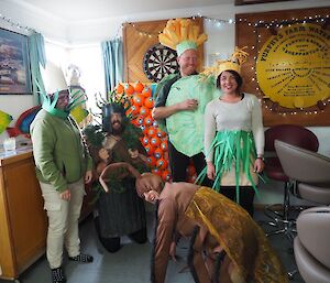 Four people in plant costumes
