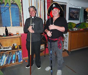 Two men in fancy dress play pool