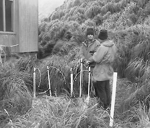 A black and white photo of two men working in front of the EPH