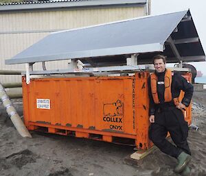 A man stands next to a container being used for remediation