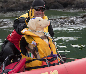 A man and the fibreglass dog on an IRB