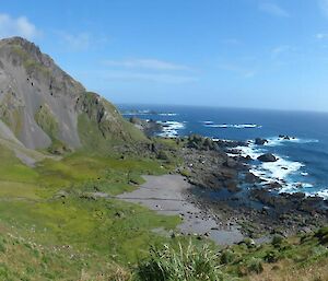 Mt Waite and Sellick Bay on the west coast of Macquarie Island. The bay has been carved from a small fault line that lies on the northern side of mountain. Over time, the gravel now observed on the scree slopes and gravelly sandy beaches has been stripped away. The massive basalt lava outcrop of Mt. Waite rises over 400m from the bay below.