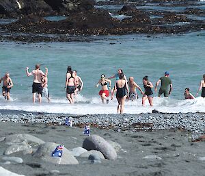 People running into the water