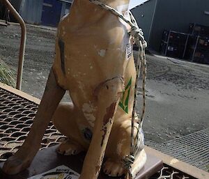 A model of a guide dog sitting out on the porch.